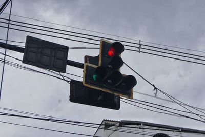 Low angle view of road signal against sky