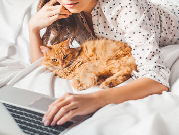 Midsection of woman with cat