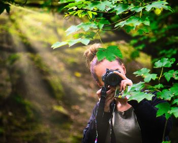 Man photographing plant