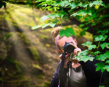 Man photographing plant