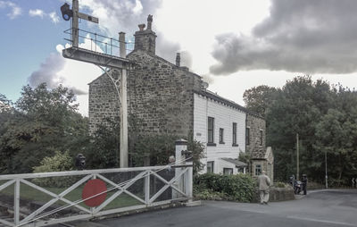 Built structure by trees against sky