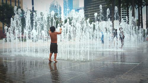 Full length of boy standing in water