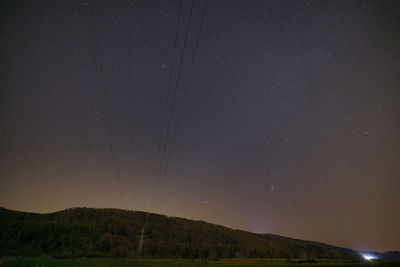 Scenic view of mountains against sky at night