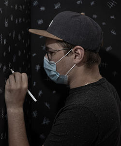 Portrait of man holding eyeglasses and counting days in quarantine