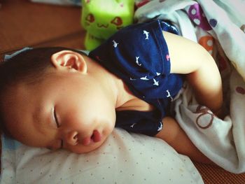 Close-up of baby sleeping on bed