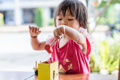 Baby girl playing with toy at home