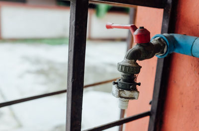 Close-up of human hand on metal railing
