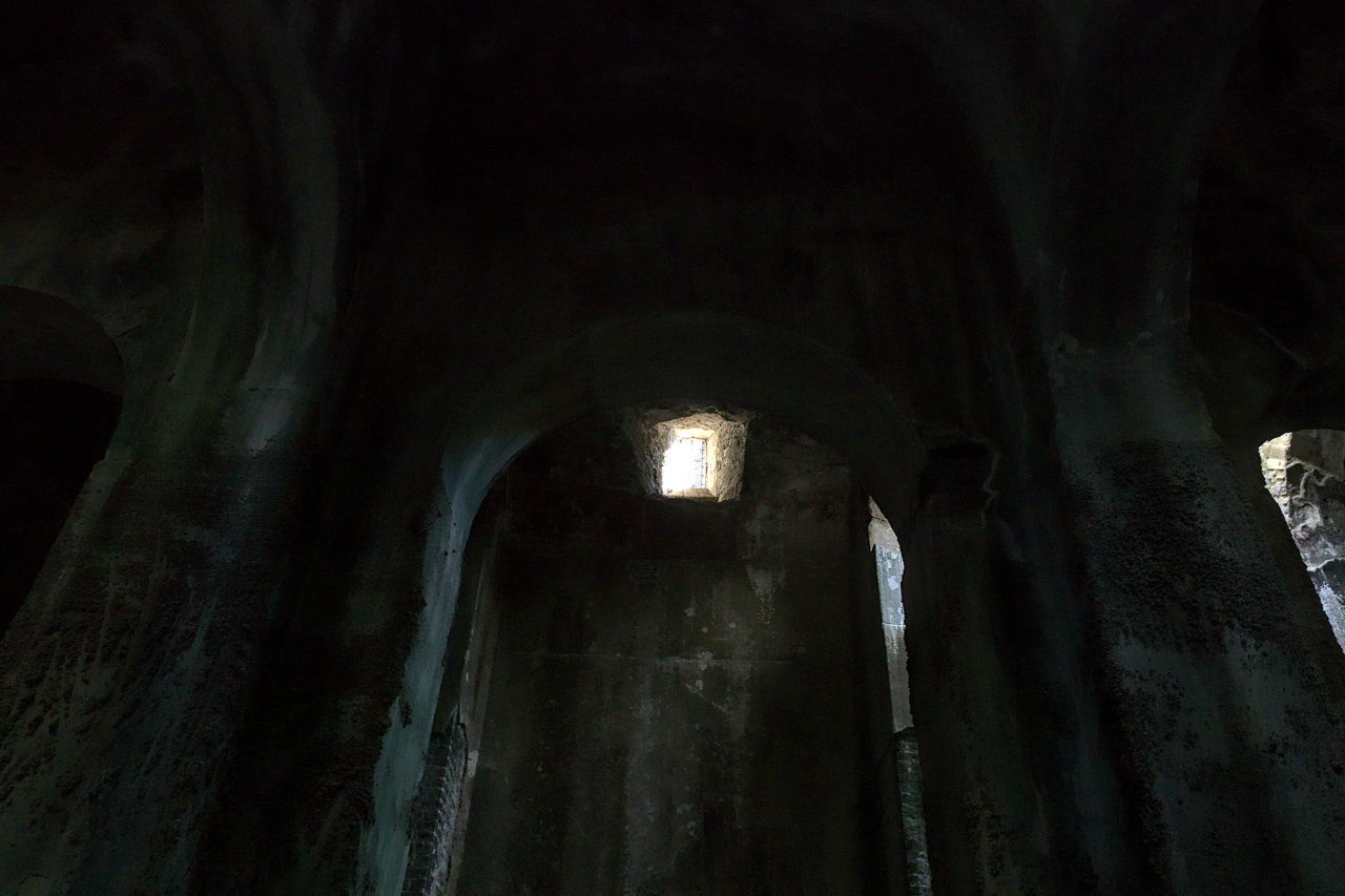 LOW ANGLE VIEW OF ILLUMINATED BUILDING IN OLD ABANDONED ROOM