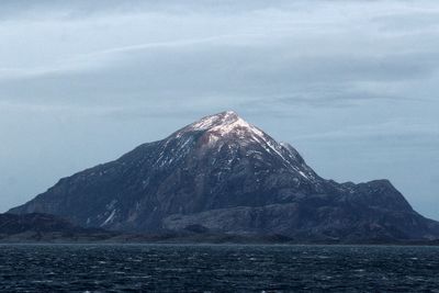 Scenic view of sea and mountains against sky