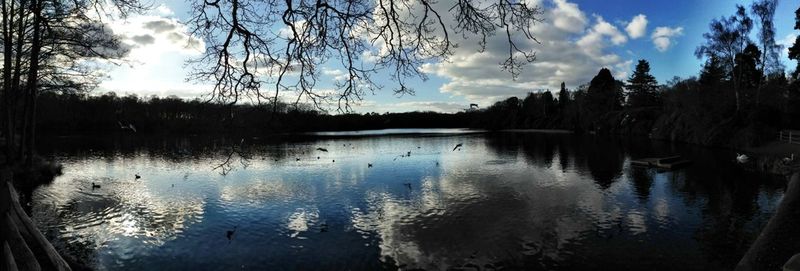 Scenic view of lake against cloudy sky