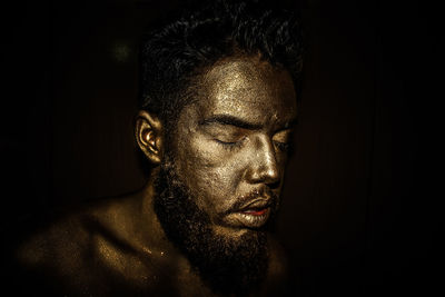 Close-up of man against black background