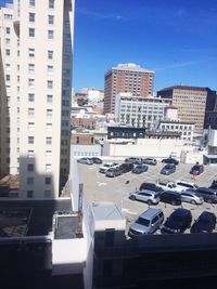 Buildings in city against blue sky