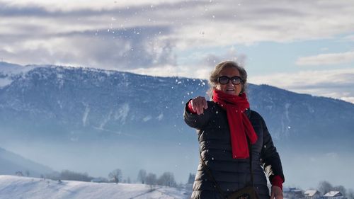 Woman standing on snow covered mountain