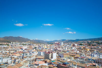 High angle view of townscape against blue sky