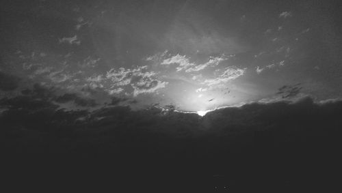 Low angle view of silhouette trees against sky