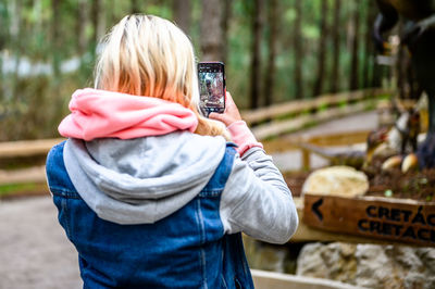 Rear view of woman photographing