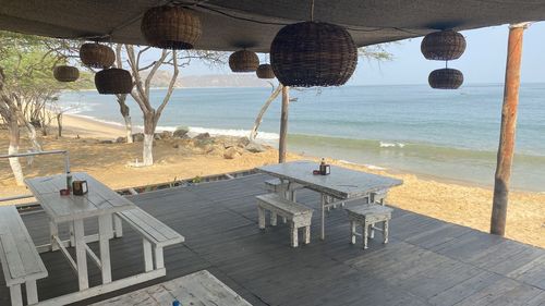 Chairs and tables at beach in restaurant