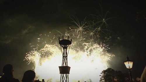 Low angle view of firework display at night