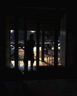 Rear view of a man in window