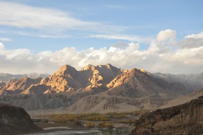 Scenic view of mountains against cloudy sky