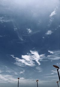 Low angle view of trees against blue sky