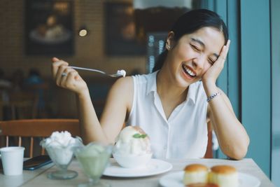 Woman with head in hand at cafe