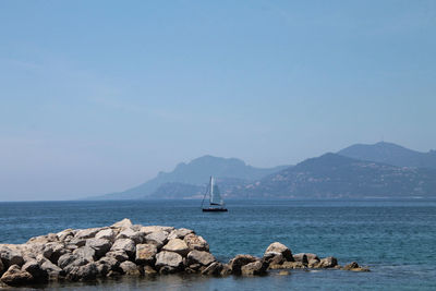 Sailboats on sea against sky