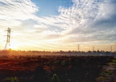 Scenic view of field against sky at sunset