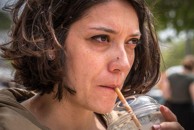 Close-up portrait of woman drinking water