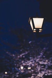 Low angle view of illuminated street light against sky at night