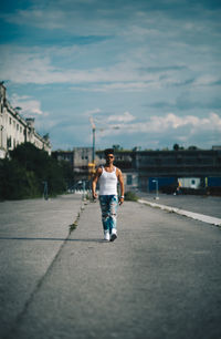 Full length of man walking on road in city