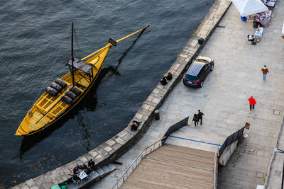  high angle view of rabelo boat and people walking along the river