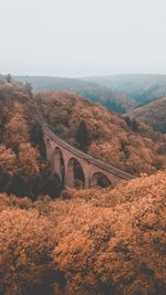 Arch bridge over mountain against sky