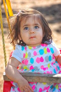 Cute baby girl sitting on swing
