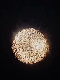 Low angle view of illuminated lights at night
