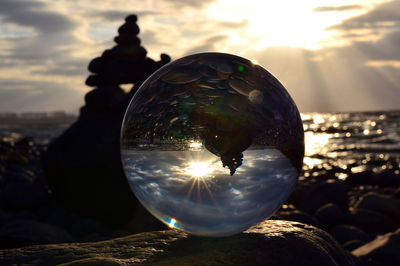Close-up of sun shining against sky