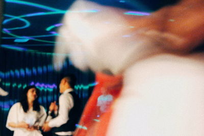 Blurred motion of people sitting at music concert