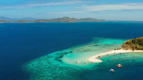 Aerial seascape tropical island with sand bar, turquoise water and coral reef. ditaytayan, palawan