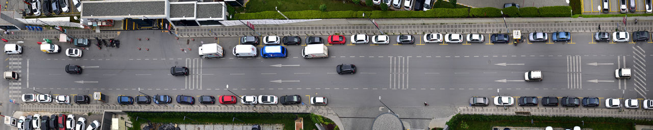 High angle view of vehicles on road along buildings