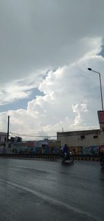 Cars on street against sky