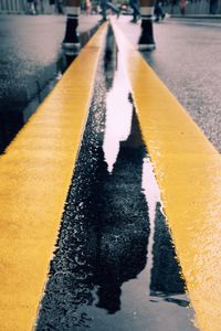 Shadow of person on road in rain