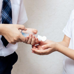 Midsection of couple holding hands