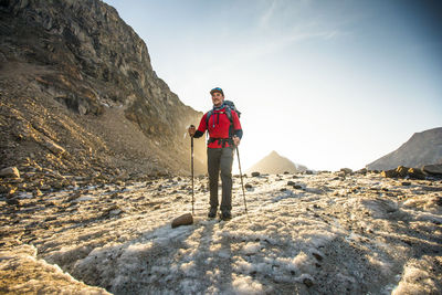 Evening light on mountaineer hiking across a glacier.