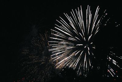 Low angle view of firework display at night