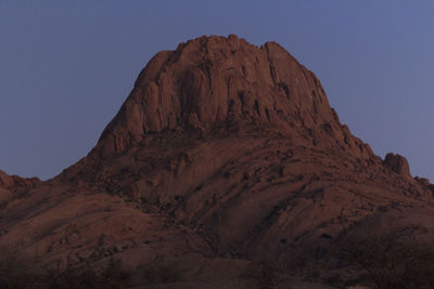 Low angle view of mountain against clear sky