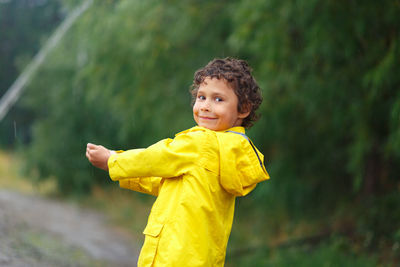 Portrait of cute boy standing outdoors