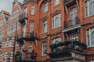 Traditional red brick apartment block with balconies in mayfair, london, uk.