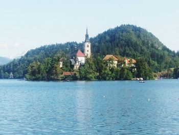 Scenic view of lake by mountain against sky