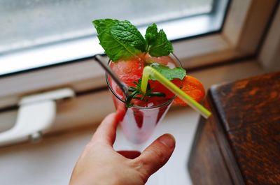 Close-up of cropped hand holding drink