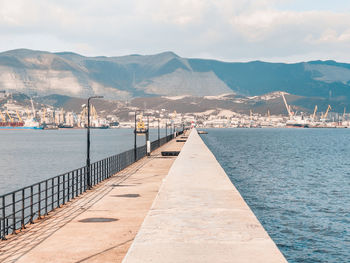 Scenic view of sea and mountains against sky